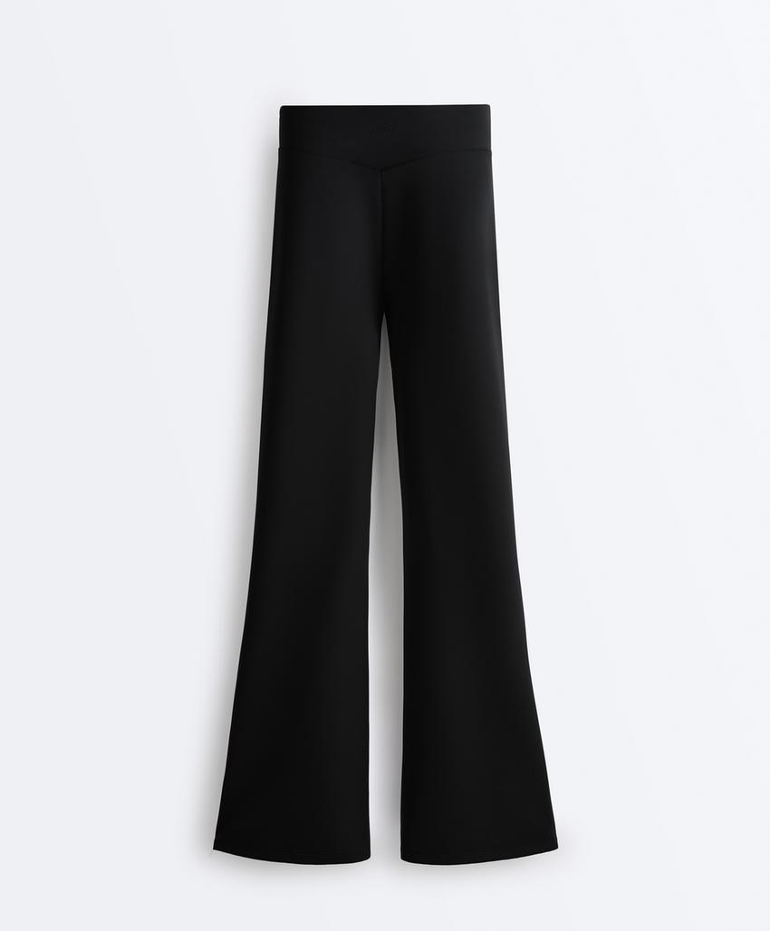 Расклешенные брюки с высокой посадкой и эффектом неопрена